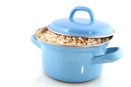 cooking brown rice in blue used panの写真素材