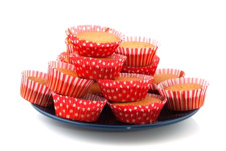 Big pile of tasty red cupcakes on a plateの写真素材