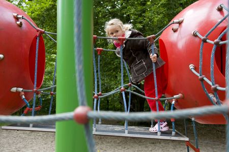 climbing and playing little girl at the playground