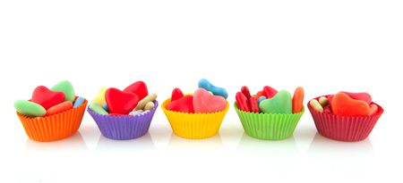 Colorful candy sweets in different shapes in paper cupsの写真素材