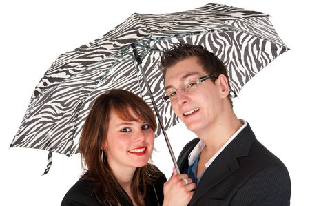 Young couple together under the black and white umbrellaの写真素材