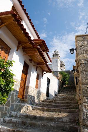 Greek village with alley and white churchの写真素材