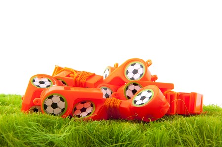 many Dutch soccer whistles in green fieldの写真素材