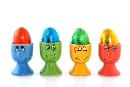 Easter eggs in funny cups isolated over white