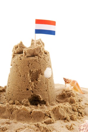 Sand castle with Dutch flag isolated over whiteの写真素材