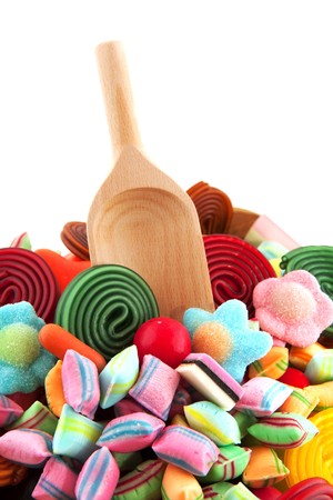 Many candy sweets with wooden spoon isolated over whiteのeditorial素材