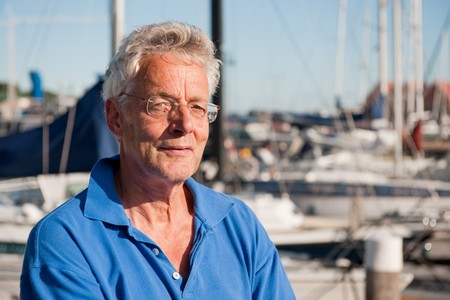 Portrait of an elderly man in harborの写真素材