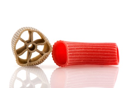 Raw colorful pasta in close up isolated over white