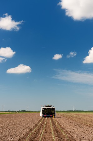 Planting vegetables with combine in the agriculture fieldsの写真素材