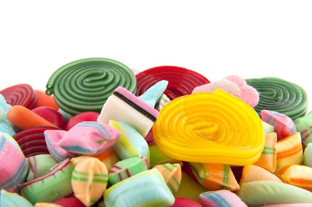 Many candy sweets with wooden spoon isolated over whiteのeditorial素材