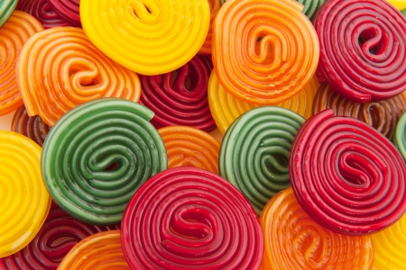 colorful licorice candy drop rolls as backgroundの写真素材