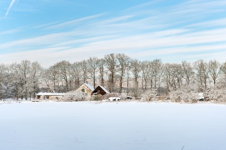 Dutch landscape with farm house in the snowの写真素材