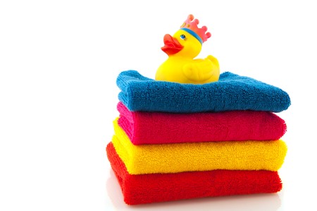 stack with colorful folded towels and a bath duckの写真素材
