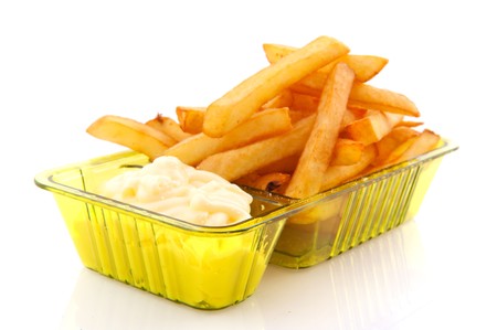Portion French fries with mayonaise isolated over white
