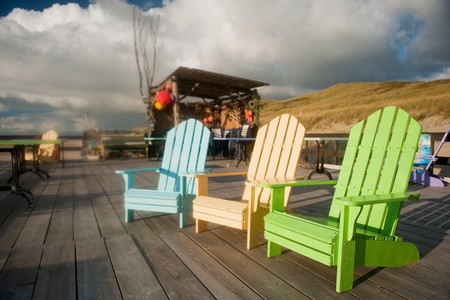 Empty colorful beach chairs at the terrace in the eveningの写真素材