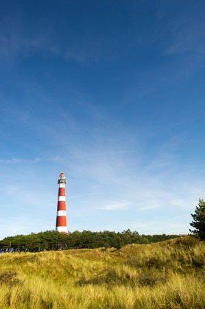 classic lighthouse in red and white at Dutch island Amelandの写真素材