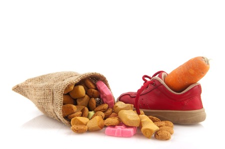 Shoe with carrot for horse of Sinterklaas and pepernoten isolated over whiteの写真素材