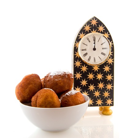 Dutch new years eve with clock and oliebollenの写真素材