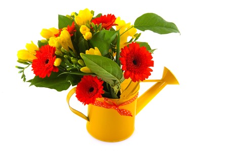 Flower bouquet with orange Gerber and yellow Freesia in watering canの写真素材
