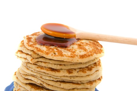 Fresh baked pancakes with wooden soon full syrupの写真素材