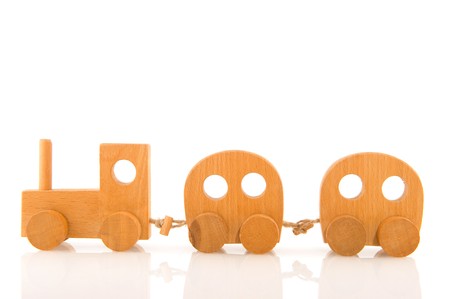wooden toy locomotive with wagons isolated over whiteの写真素材