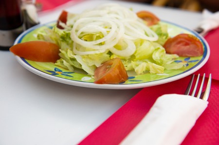 Fresh Spanish salad with vegetables at the tableの写真素材