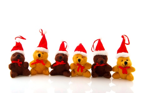 A row little christmas bears with santa claus hatの写真素材
