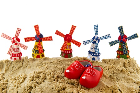 Dutch beach with windmills and wooden clogs の写真素材