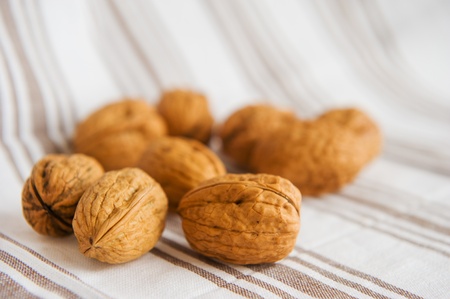 Walnuts on a textile cloth with brown stripes