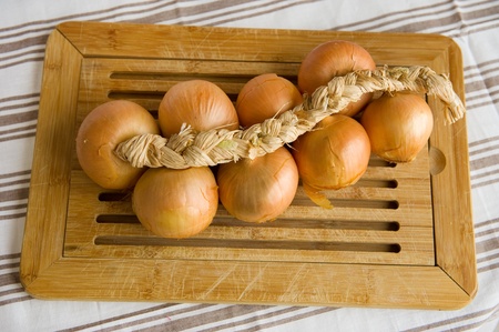 Cord with onions in rural still lifeの写真素材