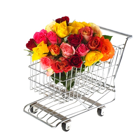 shopping cart with colorful bouquet roses isolated over whiteの写真素材