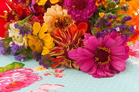 colorful flower bouquet on blue cloth with rosesの写真素材