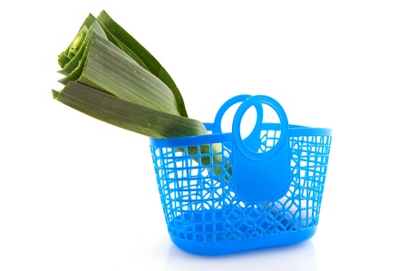 Fresh raw leek vegetables in blue shopping bagの写真素材