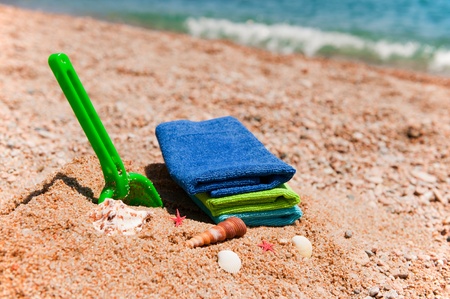 Colorful towels and toys at the summer beachの写真素材