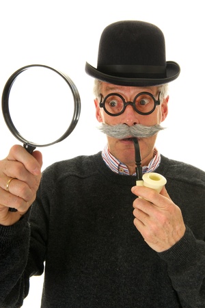 Portrait of a funny inspector with a big magnifier for investigationの写真素材