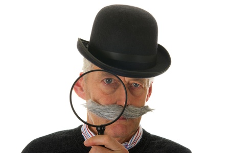 Portrait of a funny inspector with a big magnifier for investigationの写真素材