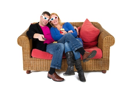 Couple is romantic sitting at the coach and looking 3D televisonの写真素材