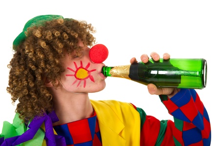 Clown is drinking with a bottle of wineの写真素材