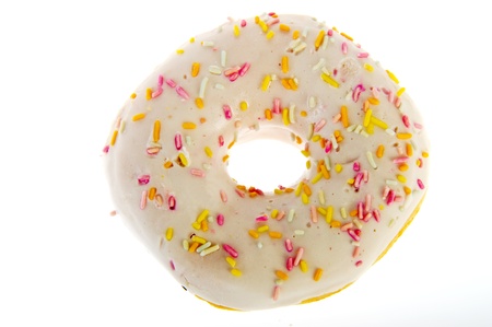 White glazed donut with colorful sprinkles on topの写真素材