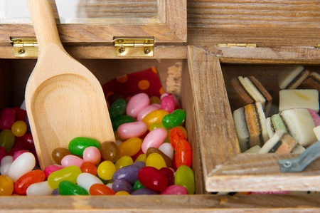 Wooden candy bar with assortment sweets isolated over whiteの写真素材