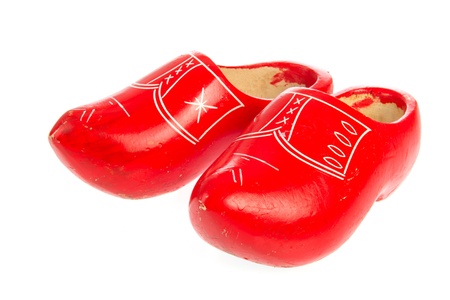 Pair of Dutch red wooden clogs isolated over white
