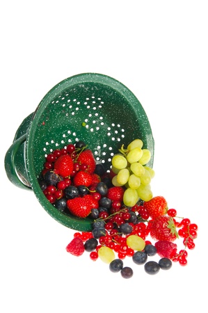Washing fresh fruit in green colander isolated over whiteの写真素材