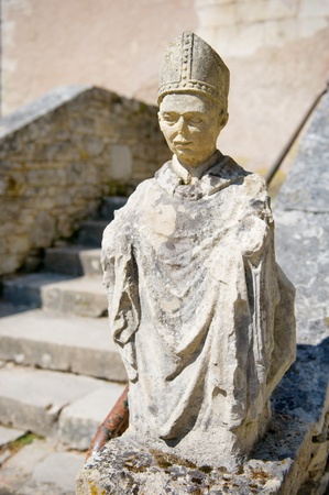 Old French sculpture of a Benedictine munch at the abbey in Tourtoiracの写真素材