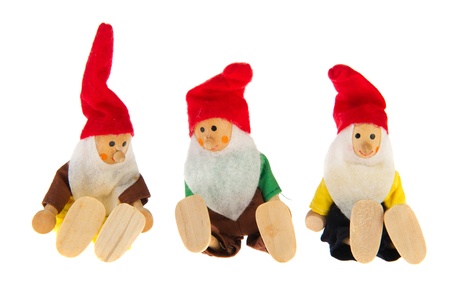 Three simple handmade gnomes isolated over white background