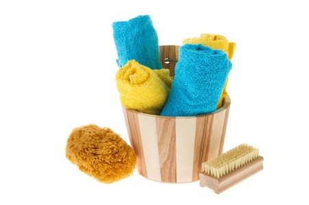 Wooden sauna bucket with sponge brush and towelsの写真素材