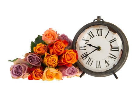 Romantic times with old antique clock and rosesの写真素材