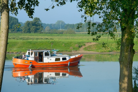 Little orange motor boat for recreation purpose in river
