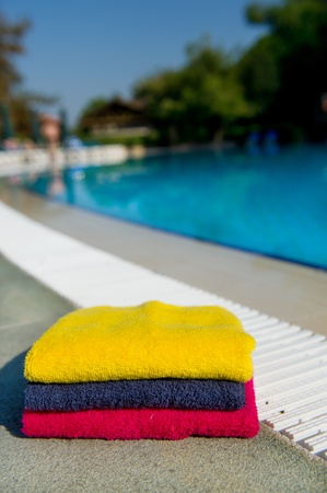 Colorful stacked towels near the swimming poolの写真素材
