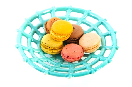 Blue plate with French Macarons isolated over white backgroundの写真素材