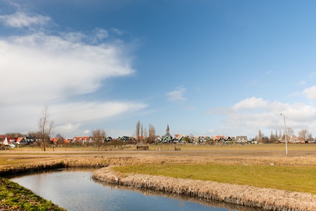 Typical Dutch village Marken with wooden green houses and small ditches